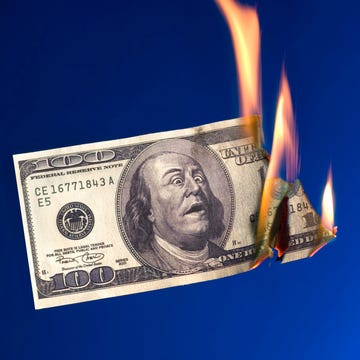 money to burn burning money on blue background
